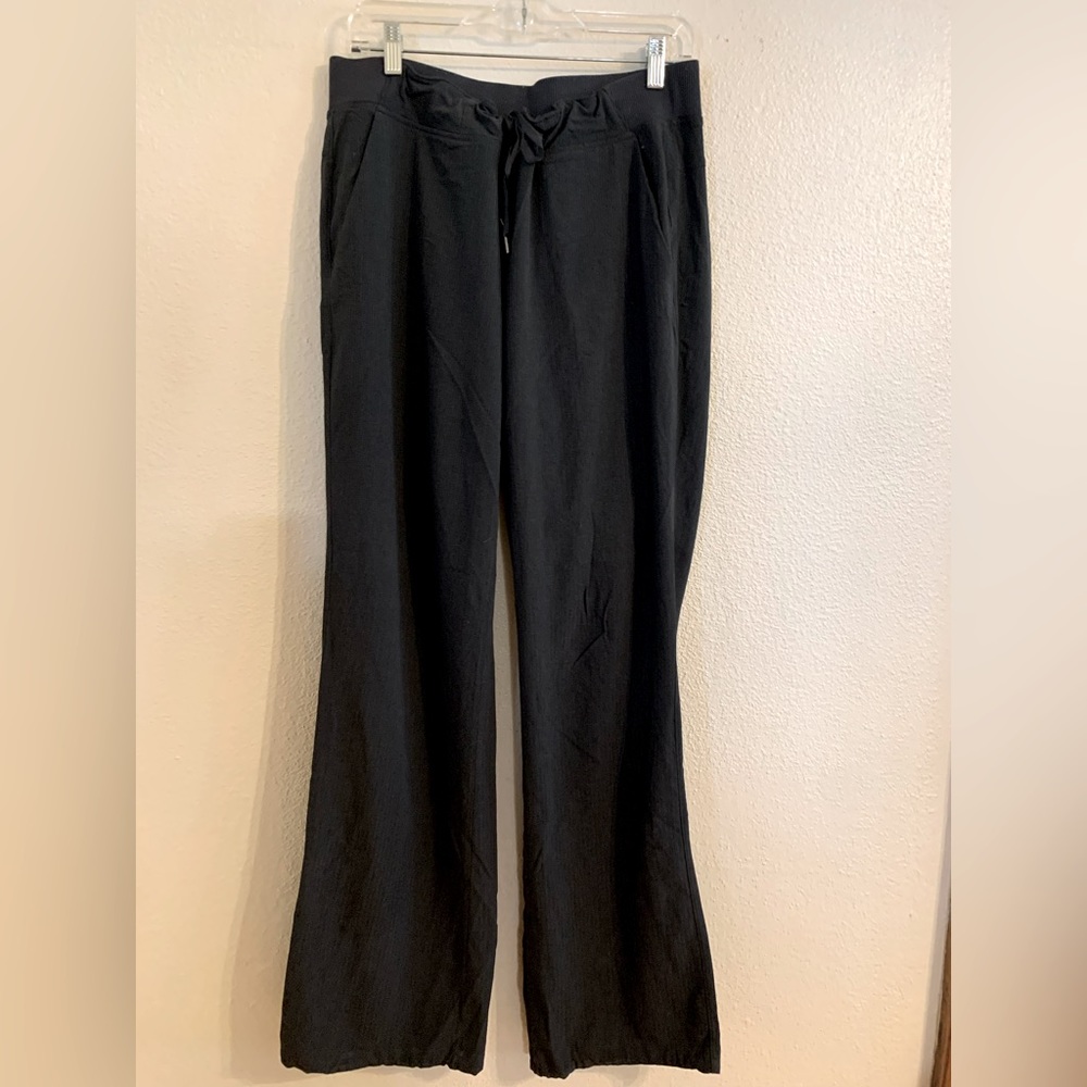 Gray Athleta pants with subtle gray on gray striping. 12 tall.